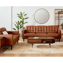 Brown leather sofa set in a living room with a coffee table and decorative items.