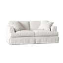 Three-quarters of a white sofa with cushions on a white background.
