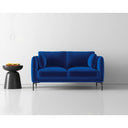 Blue sofa in a minimalistic room with a white wall and black side table.