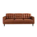Front view of the Armando mid-century modern sofa in caramel leather, featuring biscuit-tufted back cushions and dark tapered legs, on a white background.