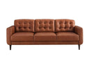Front view of the Armando mid-century modern sofa in caramel leather, featuring biscuit-tufted back cushions and dark tapered legs, on a white background.