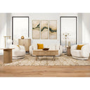The Ellie linen sofa and matching swivel armchairs styled in a luxurious modern living room with abstract art, a geometric rug, and a city view.