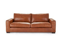 A front view of the Kennon contemporary leather sofa in a cognac color, featuring wide track arms, plush cushions, and low block feet, on a white background.