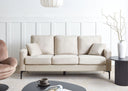 Light beige sofa in a modern living room with a coffee table and decorative items.