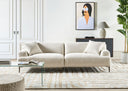 Contemporary living room with a beige sofa, glass coffee table, and decorative elements.