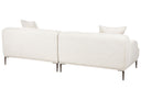 Back view of a contemporary, low-profile, light-colored fabric sofa with two throw pillows and tapered metal legs on a white background, showing its modular design
