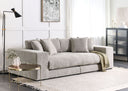 Gray sofa in a modern living room with a side table and lamp.