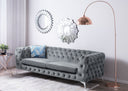 Gray tufted sofa with decorative pillows in a modern living room setting.
