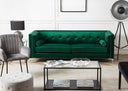 Green sofa in a modern living room with a gray chair and coffee table.
