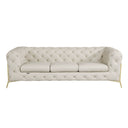 Front view of a beige tufted sofa with gold legs on a white background.
