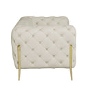 Side view of a beige tufted sofa with gold legs on a white background.
