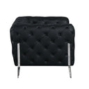 Side view of a black tufted sofa with chrome legs on a white background.