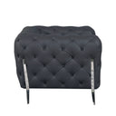 Side view of a grey tufted sofa with chrome legs on a white background.