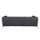 Rear view of a grey tufted sofa with chrome legs on a white background.