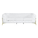 Front view of a white tufted sofa with gold legs on a white background.