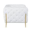 Side view of a white tufted sofa with gold legs on a white background.