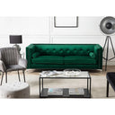 Modern living room with an emerald green sofa, gray chair, and coffee table.