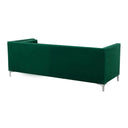 Three-quarters rear view of a luxurious emerald green velvet sofa, tufted and adorned with silver studs, includes matching bolster pillows on a white background.