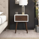 Wooden nightstand with white top in a bedroom setting