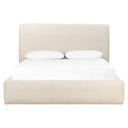 Cream upholstered bed with white bedding on a white background