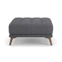 Gray upholstered ottoman with wooden legs on a white background