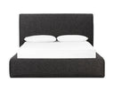 Black upholstered bed with white bedding on a white background