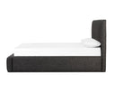 Modern bed with dark upholstered frame and white mattress on a white background