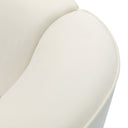 Close-up of an off-white curved sofa with a velvet upholstery on a white background.
