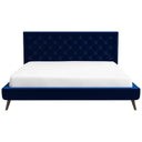 Blue tufted bed with white mattress on a white background