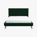 Green tufted bed with white mattress on a white background