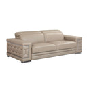 Three-quarters view of a beige leather sofa with decorative armrests on a white background.
