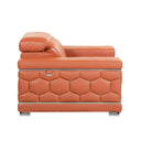 Side view of a camel leather sofa with decorative armrests on a white background.