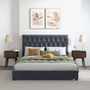 Modern bedroom with a gray upholstered bed, wooden nightstands, and wall art.
