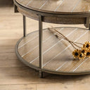 Round wooden coffee table with wooden legs on a wooden floor