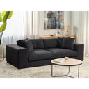 Black sofa in a living room setting with a coffee table and decorative items.