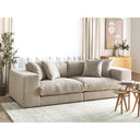 Beige sofa in a living room setting with decor elements.