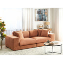Orange sofa in a living room with a coffee table and decorative items.