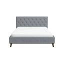 Light gray upholstered bed with white mattress on a white background