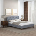 Modern bedroom with a light gray upholstered bed, wooden nightstands, and lamps.