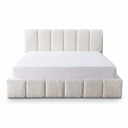 White boucle upholstered bed with a white mattress on a white background