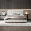 Modern bedroom with a tufted bed and decorative elements.