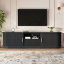 Black entertainment console with a TV above it in a living room setting.
