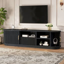 Black entertainment console with a TV above it in a living room setting.