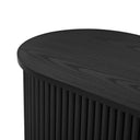 Close-up of a black cylindrical entertainment console with ribbed design on a white background