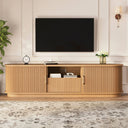 Wooden TV stand with a television mounted on a wall in a living room setting.