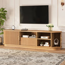 Wooden TV stand with a television mounted above it in a living room setting.
