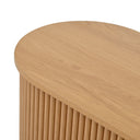 Wooden side table with a round top and vertical slat design on a white background