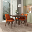 Dining room with a wooden table and burnt orange chairs, large window, and kitchen area.