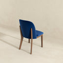 Blue chair with wooden legs on a beige background