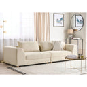 Light beige sectional sofa in a living room setting with decor elements.